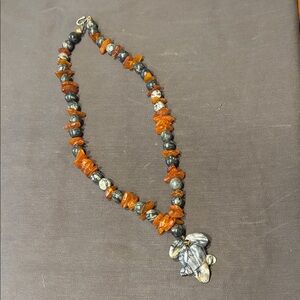 Carved frog pendant stone bead necklace.